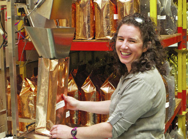 Bonnie Nowik-Cohen grinds coffee at Cape Cod Coffee Roasters
