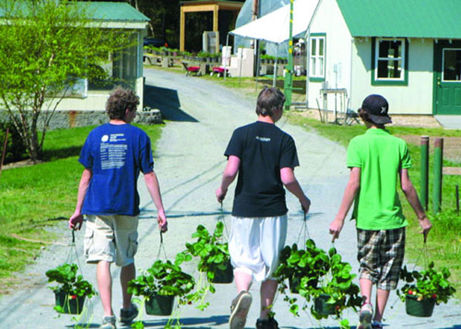 School kids carry plants to garden through Edible Schoolyards
