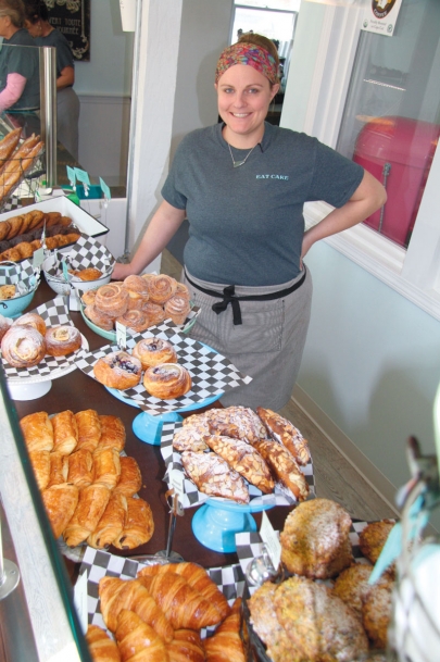 Danielle Nettleton, owner/baker of Eat Cake 4 Breakfast, alongside a display of her baked goods. 